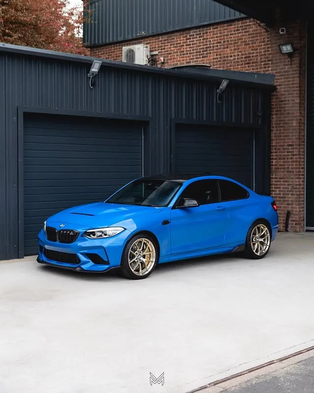 Blue BMW M2 with gold wheels