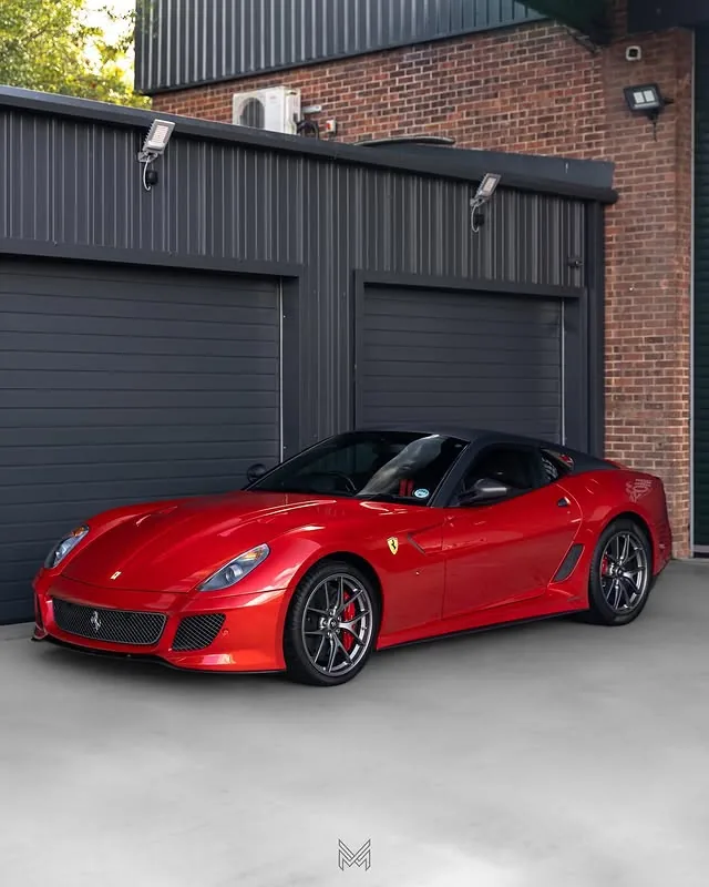 Red Ferrari 599 GTO outside the workshop